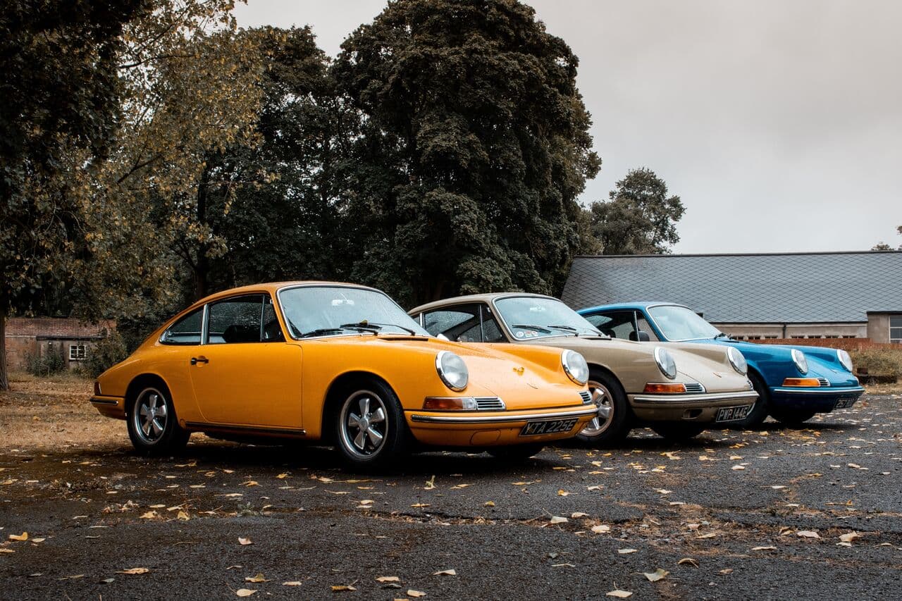Three classic Porsche 911s parked in a row