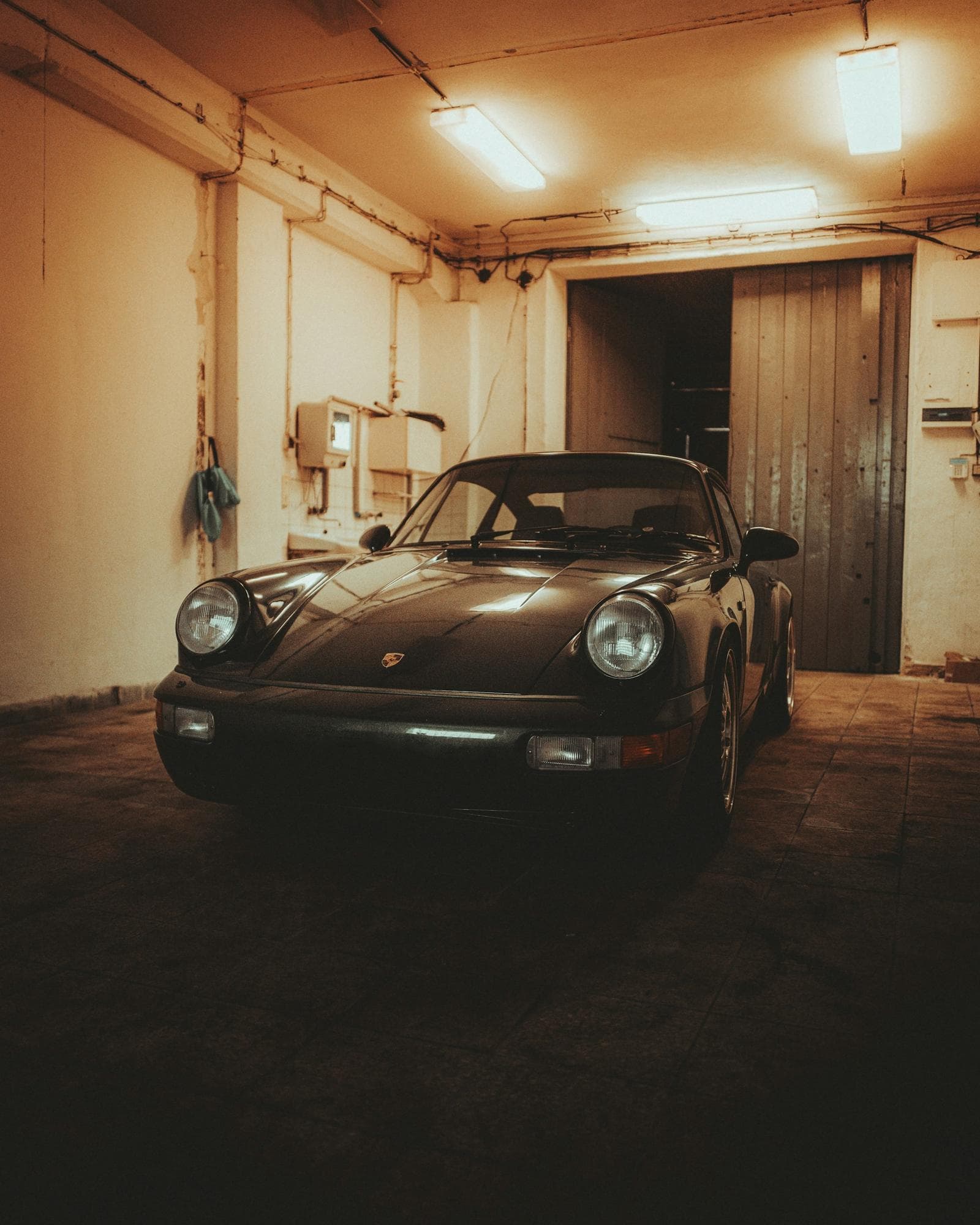 A classic Porsche 911 parked on its own in a private garage